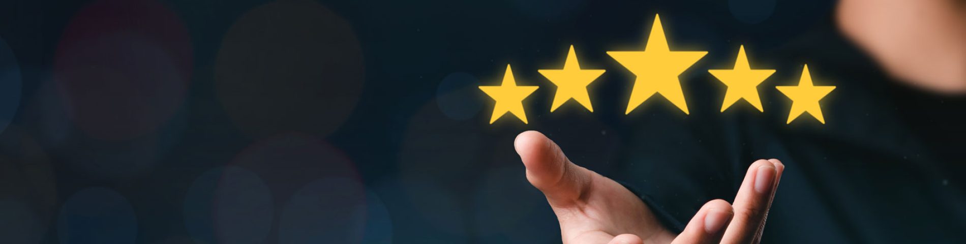 A hand is shown under a series of five star icons against a dark background, suggesting high ratings or quality.